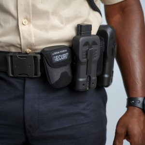 Generate image of an Africa security guards._Shirt of the uniform should be cream color and pants should be black._Guard should be well eqipped Generate image of an Africa security guards._Shirt of the uniform should be cream color and pants should be black._Guard should be well eqipped
